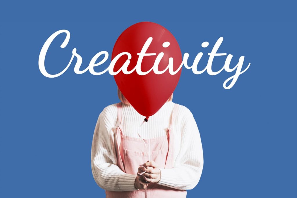 A child holding a balloon with the word “Creativity” superimposed.