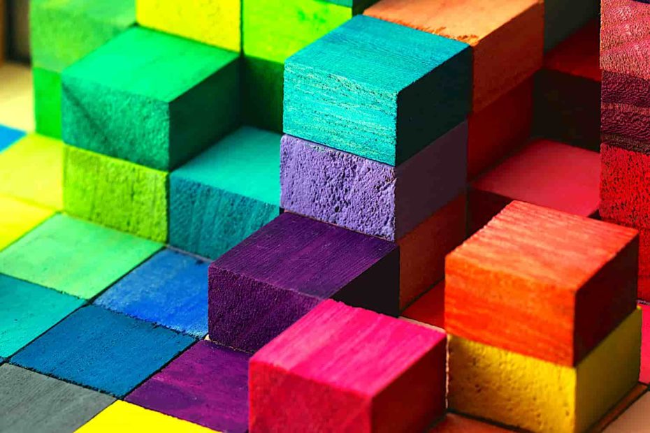Colorful wooden children’s blocks stacked to various heights.