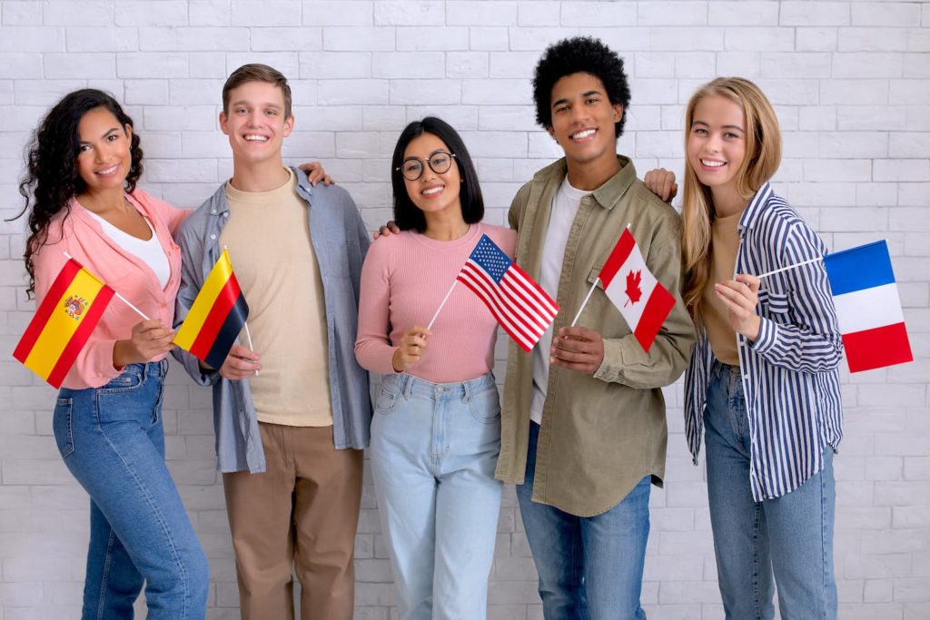 A group of exchange students holding the flags of their countries.