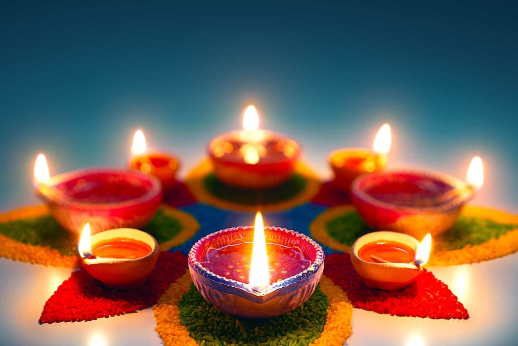 Eight Diwali oil lamps arranged in a decorative star pattern.