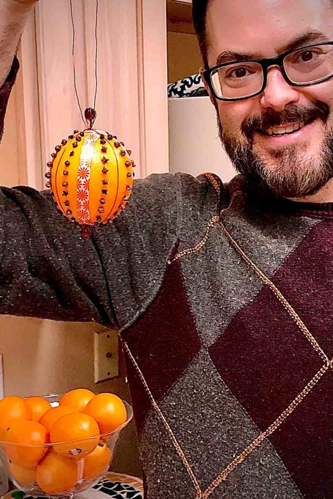 A picture of Matt Desing holding up a home-made pomander ball.