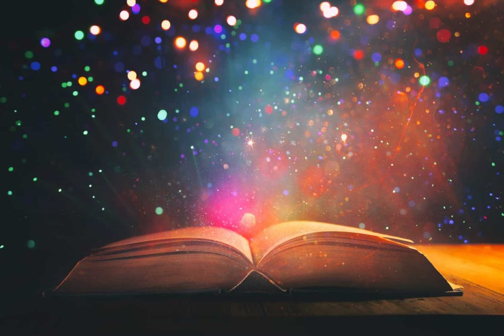 A picture of an open book emanating magical lights.