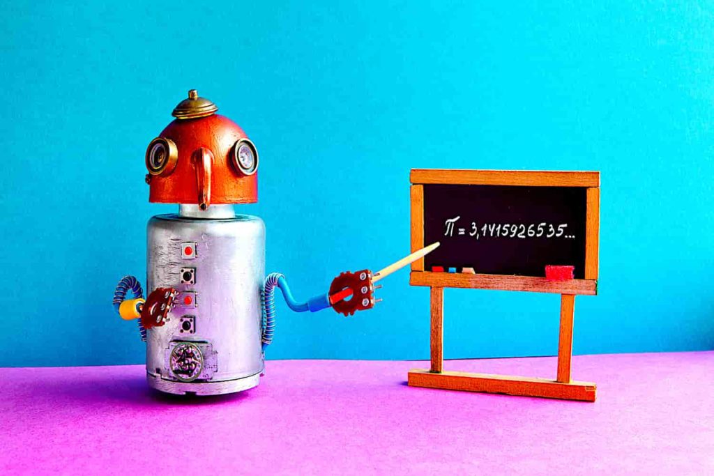 A steampunk robot posed as a teacher in front of a chalkboard.