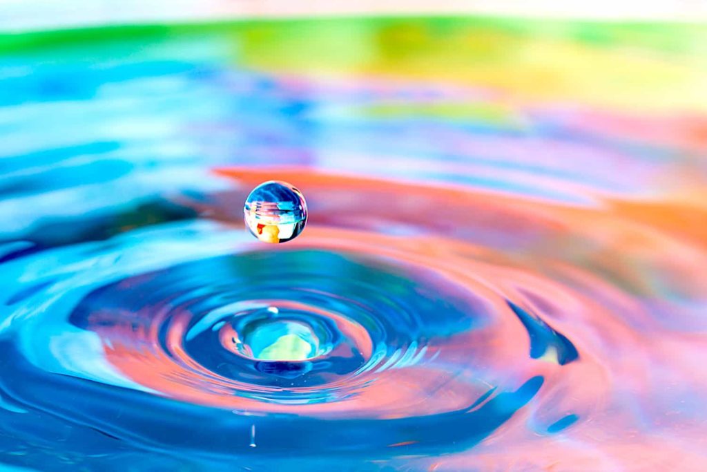 A photograph of a drop of water hitting a pond.