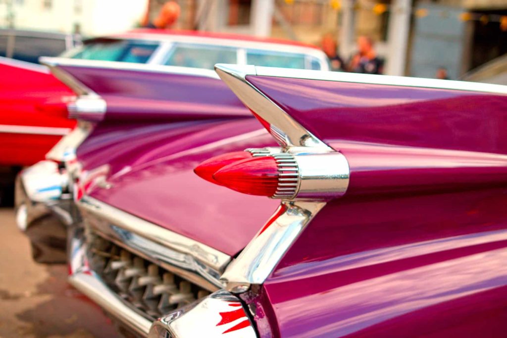 A photo of a classic car of the 1950s painted purple.