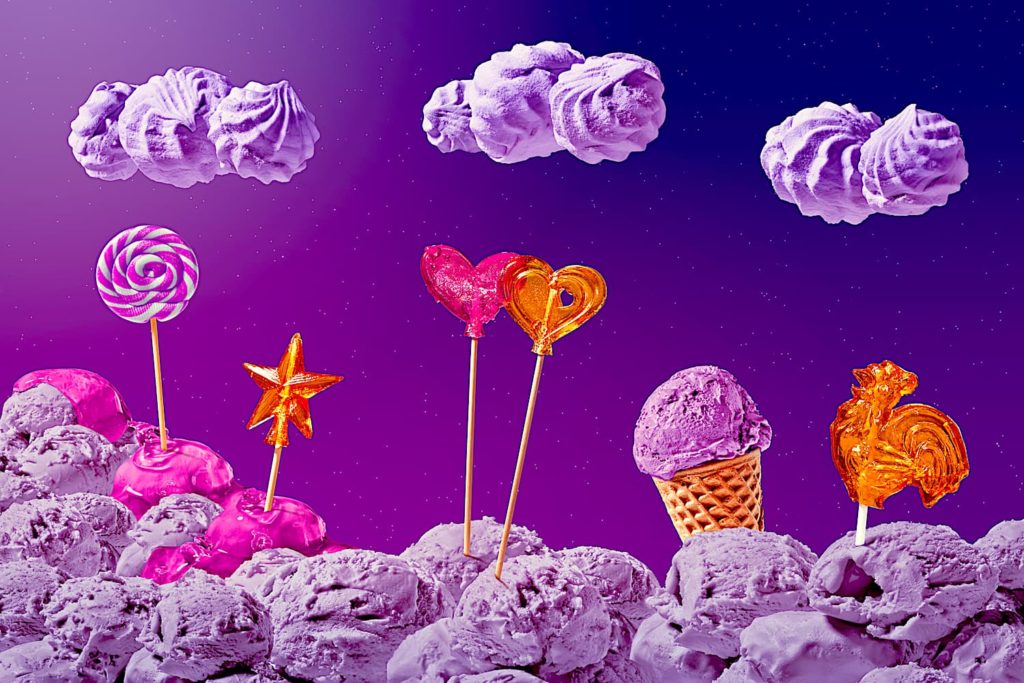 A fanciful landscape of sweet treats featuring scoops of purple ice cream.